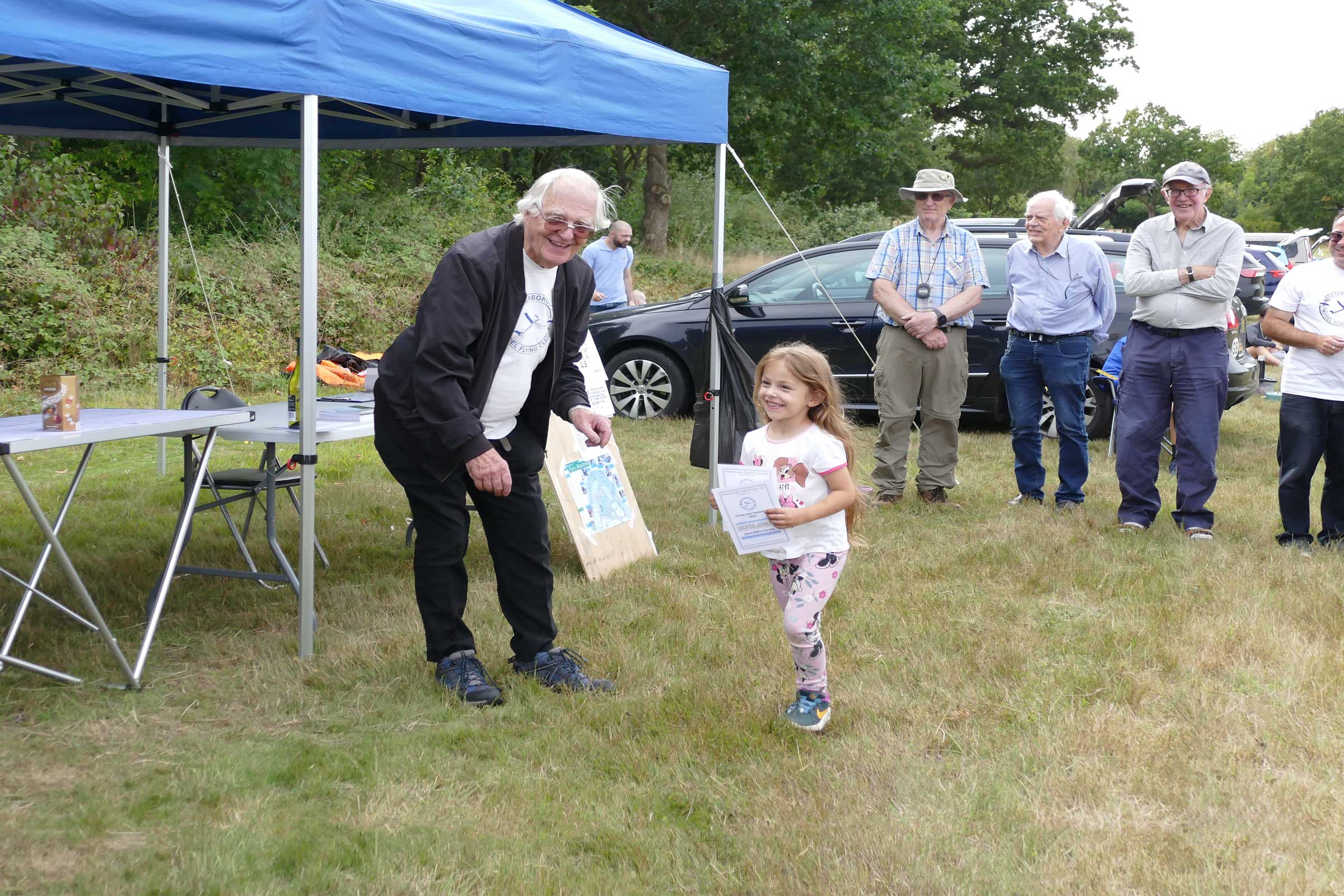 Luna Goymour collecting certificates for herself and her cousin, Isla Goymour, who became the Young Flying Ace at the 2025 Flying Aces.